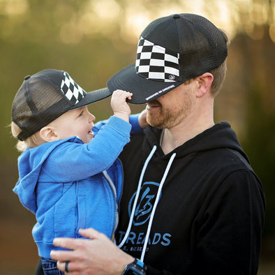 Shop online for snapback hats from LB Threads for baby, toddler, kid and adult. Father and son models wearing matching adult and kid LB Threads Checkers or Wreckers hat, a 7-panel checkered flag snapback trucker hat.