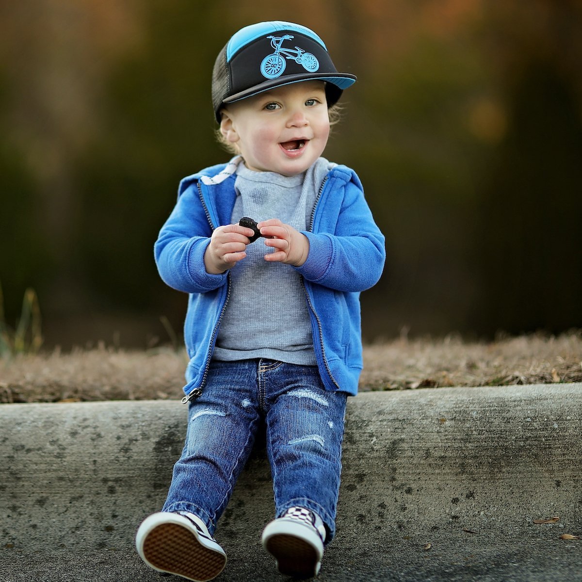 Shop online for our best selling snapback hats from LB Threads for baby, toddler, and kid. Model wearing the LB Threads BMX hat, a black and blue 7-panel trucker snapback hat.