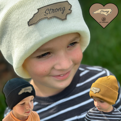 Shop online for beanies and snapback hats from LB Threads for babies, toddlers, kids and adults. Toddler model wearing our Carolina Strong Beanie, a warm, soft, cream acrylic beanie with a pressed on engraved leather custom Carolina Strong patch.