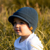 Shop online for beanies and snapback hats from LB Threads for babies, toddlers, kids and adults. Toddler model wearing the LB Threads Slate Blue Visor Beanie, a warm, soft, slate blue acrylic beanie with a flexible visor.