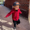 Shop online for snapback hats from LB Threads for baby, toddler, kid and adult. Toddler model wearing the LB Threads Jackson hat, a classic, charcoal herringbone-patterned, wool-blend snapback hat with a brown leather, rectangular LB Threads Big Style, Big Send patch.