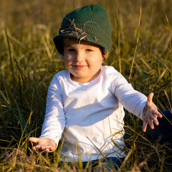 Shop online for beanies and snapback hats from LB Threads for babies, toddlers, kids and adults. Toddler model wearing the LB Threads Forest Green Visor Beanie, a warm, soft, forest green acrylic beanie with a flexible visor.