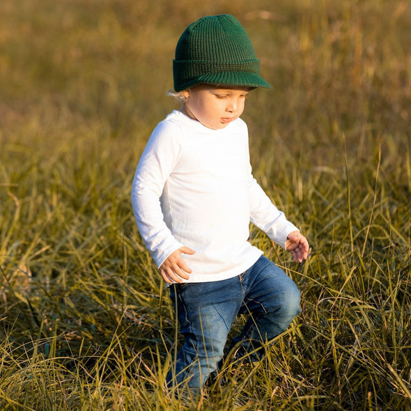 Shop online for beanies and snapback hats from LB Threads for babies, toddlers, kids and adults. Toddler model wearing the LB Threads Forest Green Visor Beanie, a warm, soft, forest green acrylic beanie with a flexible visor.